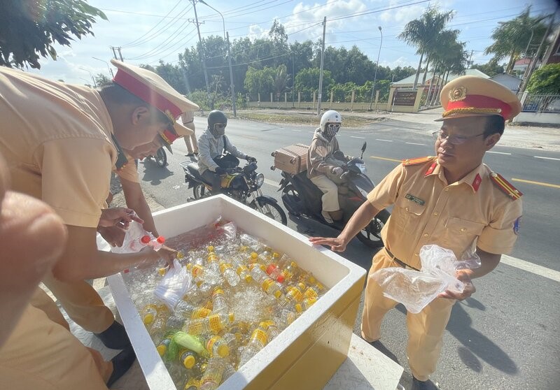 Chuẩn bị khăn lạnh, nước lọc tặng cho người dân tham gia giao thông. Ảnh: Nhật Hồ