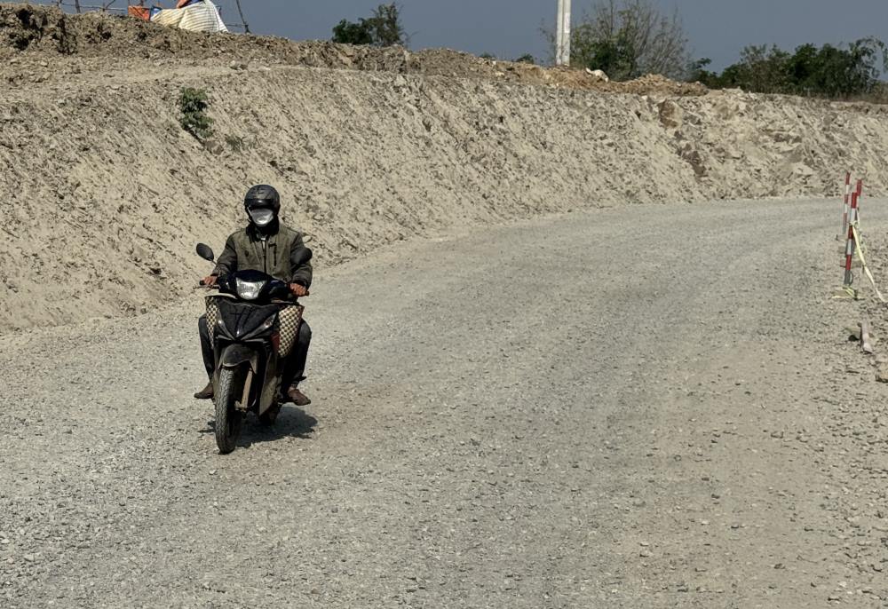Xe máy từ từ di chuyển trên đường sỏi. Ảnh: Duy Tuấn