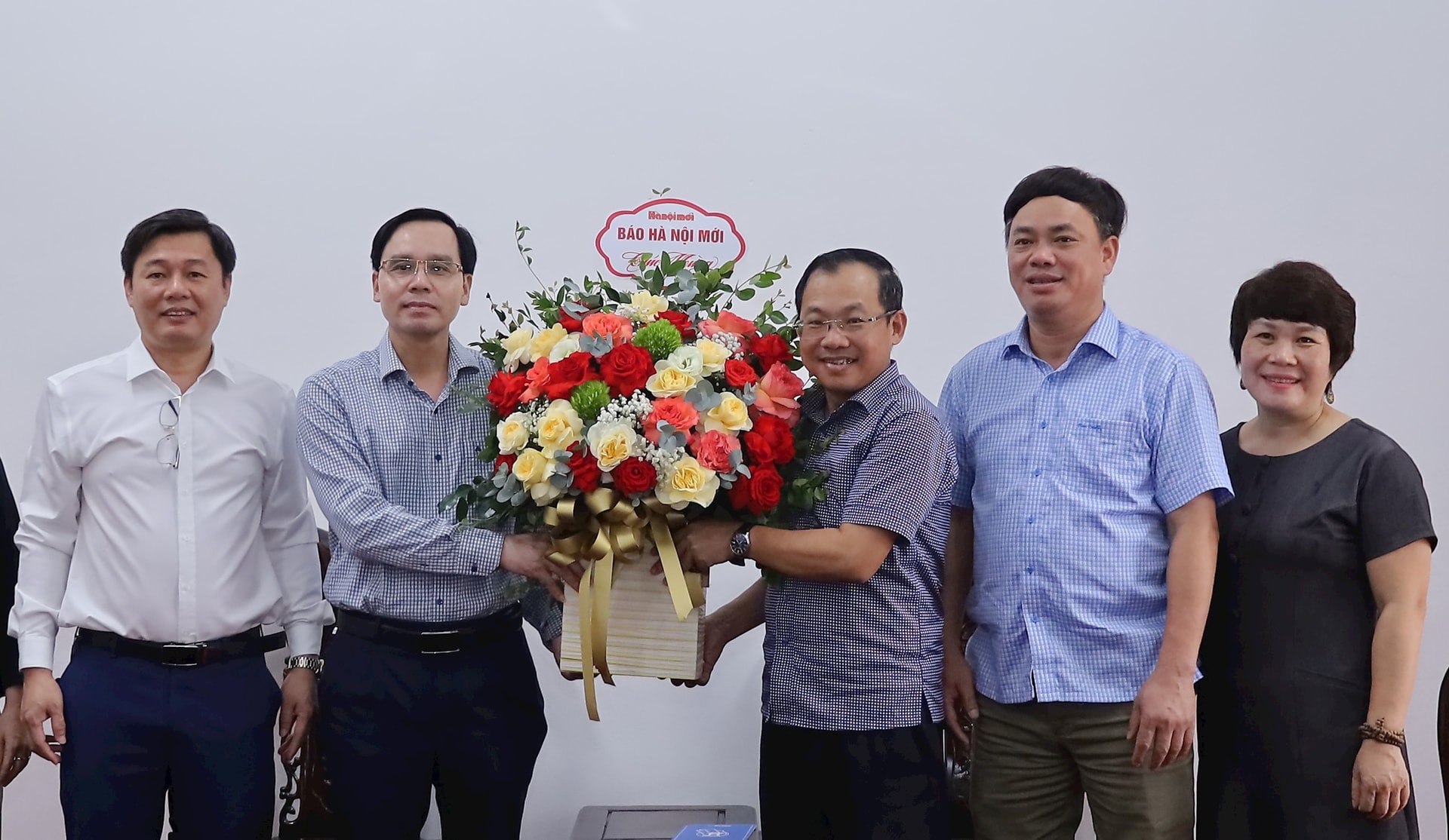 Đoàn công tác Báo Hànộimới tặng hoa chúc mừng đại diện lãnh đạo Đảng ủy, HĐND, UBND, MTTQ Việt Nam xã Phú Nghĩa mới thành lập theo mô hình chính quyền địa phương hai cấp. Ảnh: Kim Nhuệ